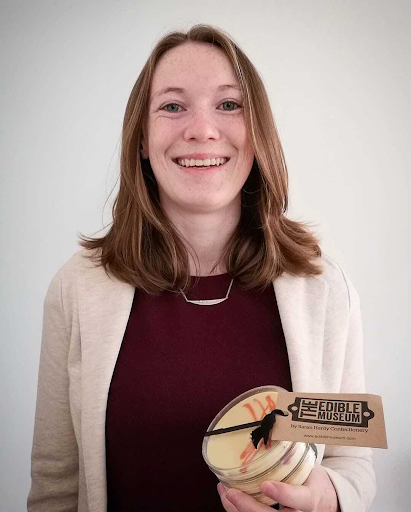 Female scientist holding chocolate petri dish