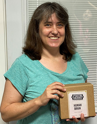 Female scientist displaying chocolate brain.