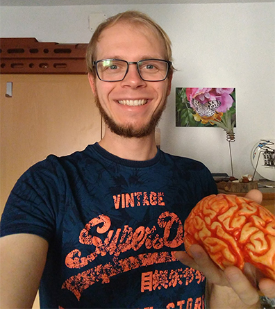 Male scientist displaying chocolate brain.
